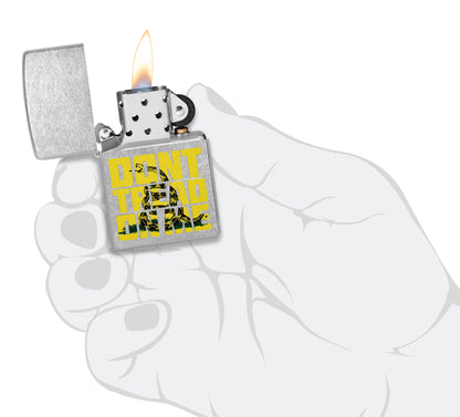 Zippo Donâ€™t Tread on Me Street Chrome Windproof Lighter lit in hand.
