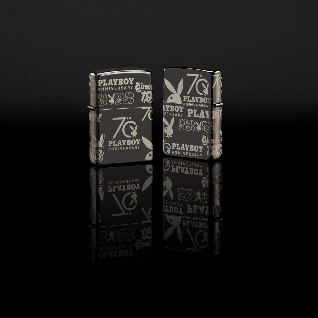 Glamour shot of Zippo Playboy 70th Anniversary High Polish Black Windproof Lighter standing in a black scene.