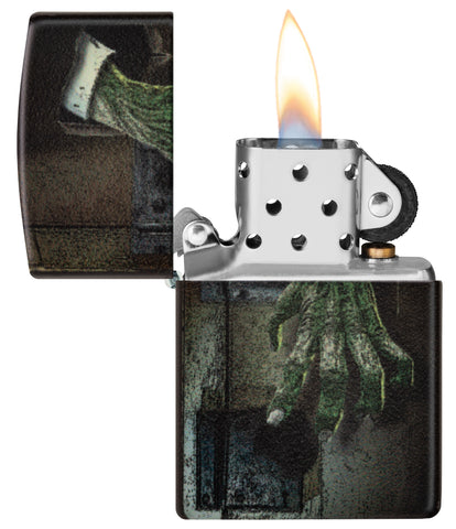 Glow In the Dark Zombie Hand Windproof Lighter with its lid open and lit.