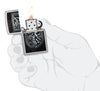 Zippo Dragon Shield Design Street Chrome Windproof Lighter lit in hand.