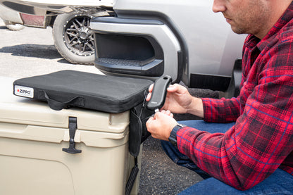 Lifestyle image of Zippo Heated Seat - Single, with a man plugging in HeatBank® 9s (not included)