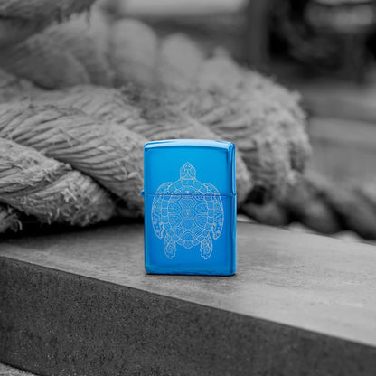 Lifestyle image of Zippo Zen Turtle Design High Polish Blue Windproof Lighter standing in front of a rope on a wooden plank.