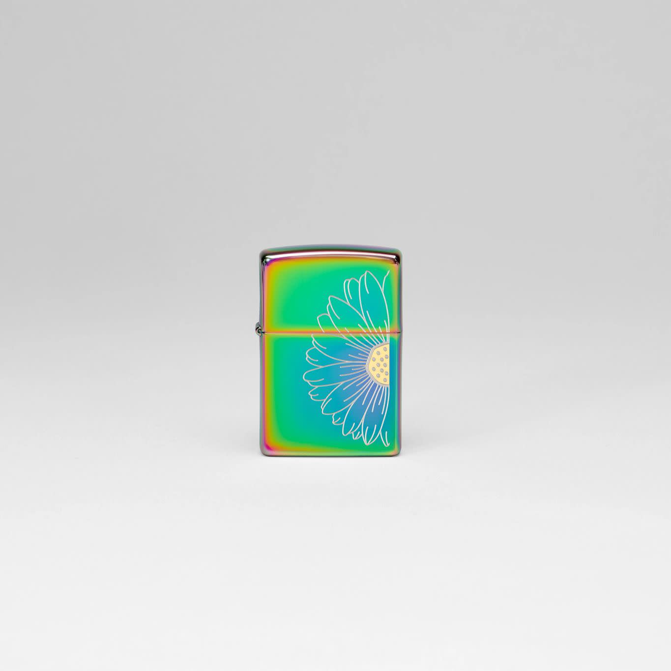 Lifestyle image of Zippo Daisy Design Multi Color Windproof Lighter standing in a grey scene.