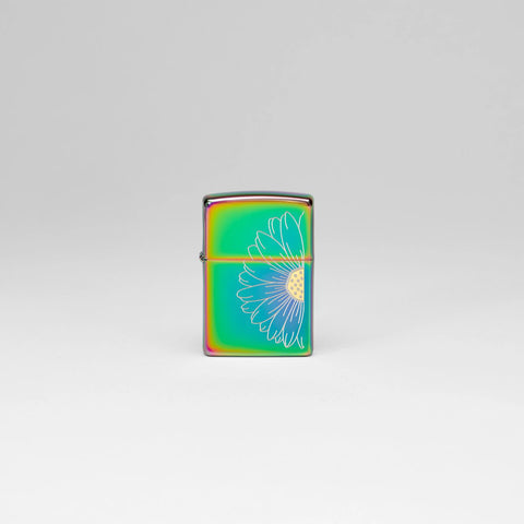 Lifestyle image of Zippo Daisy Design Multi Color Windproof Lighter standing in a grey scene.