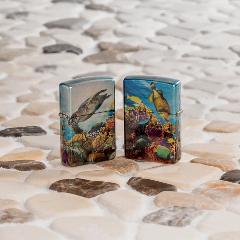 Lifestyle image of two Zippo Deep Sea Design 540 Tumbled Chrome Windproof Lighters standing on a sandy tiled surface.