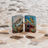 Lifestyle image of two Zippo Deep Sea Design 540 Tumbled Chrome Windproof Lighters standing on a sandy tiled surface.