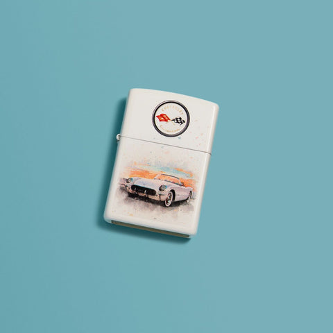Lifestyle image of Chevy Vintage Corvette White Matte Windproof Lighter laying on a turquoise background.