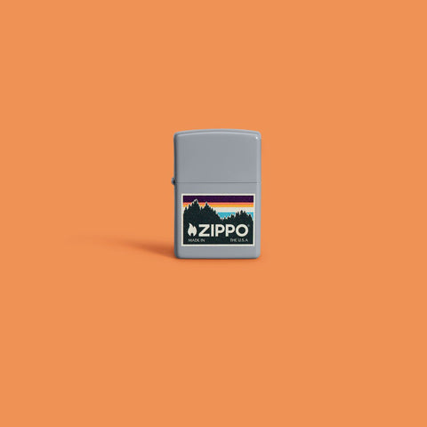 Lifestyle image of Outdoor Zippo Logo Design Flat Grey Windproof Lighter on an orange background.