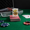 Lifestyle image of Drippy Dollar Design Mercury Glass Windproof Lighter standing on a deck of cards on a poker table, with poker chips scattered around.