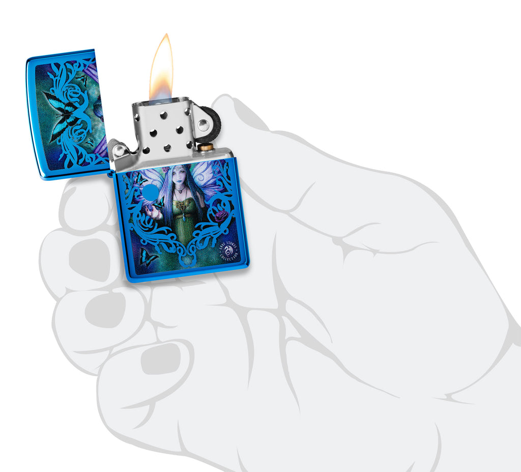 Zippo Anne Stokes Collection High Polish Blue Windproof Lighter lit in hand.