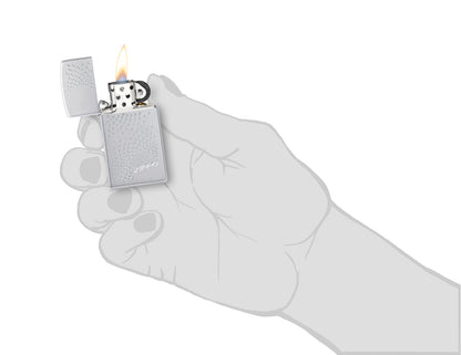 SlimÂ® Zippo Dot Design Satin Chrome Windproof Lighter lit in hand.