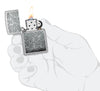 Zippo Vines Design Street Chrome Windproof Lighter lit in hand.