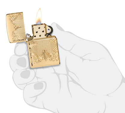 Zippo Lucky Clover Design ArmorÂ® High Polish Gold Plate Windproof Lighter lit in hand.