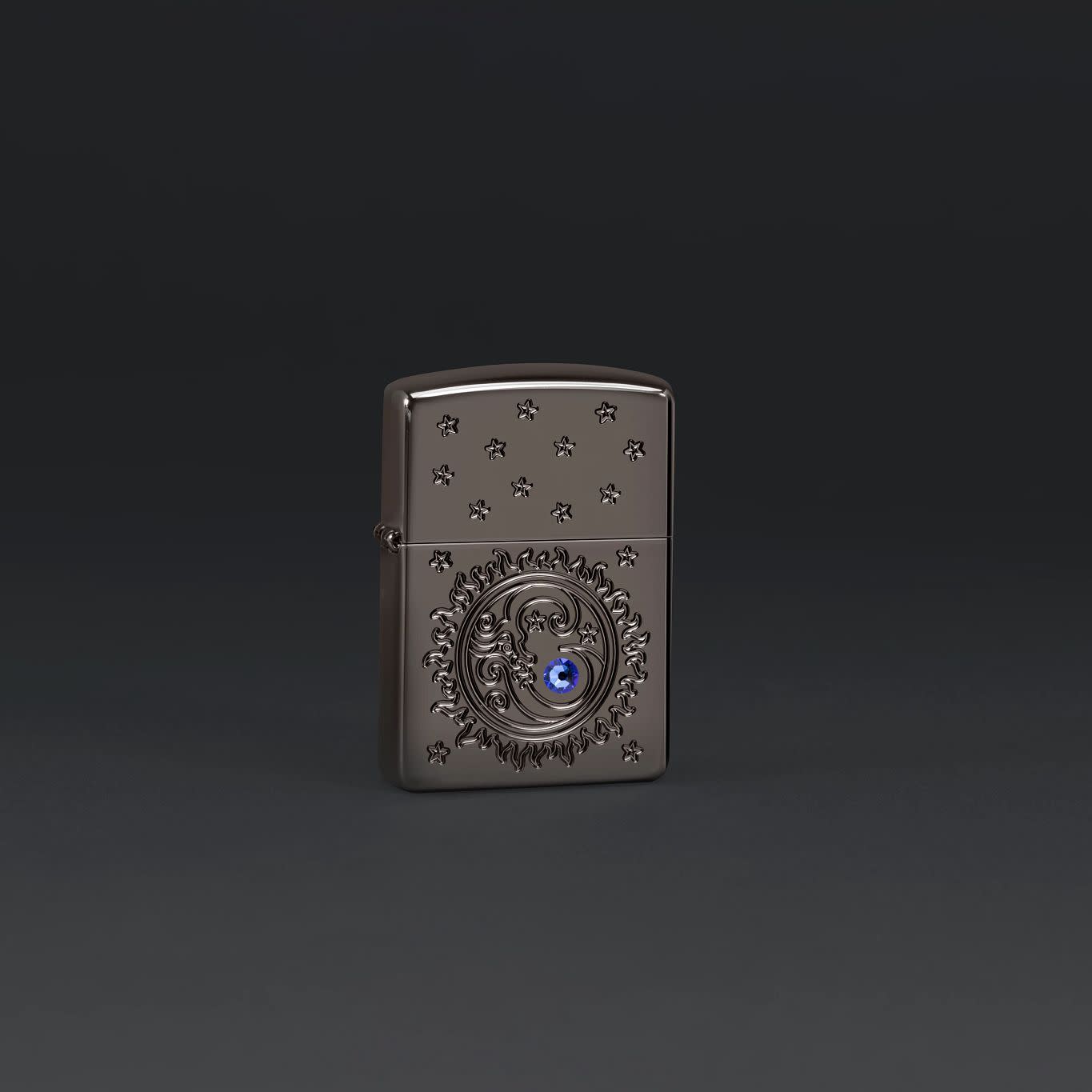 Lifestyle image of Zippo Ocean Crystal Black IceÂ® Windproof Lighter on a dark grey background.