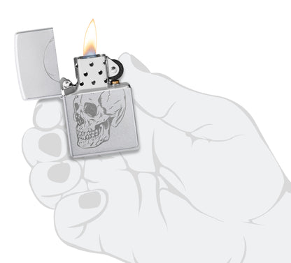 Zippo Subtle Skull Design Satin Chrome Windproof Lighter lit in hand.