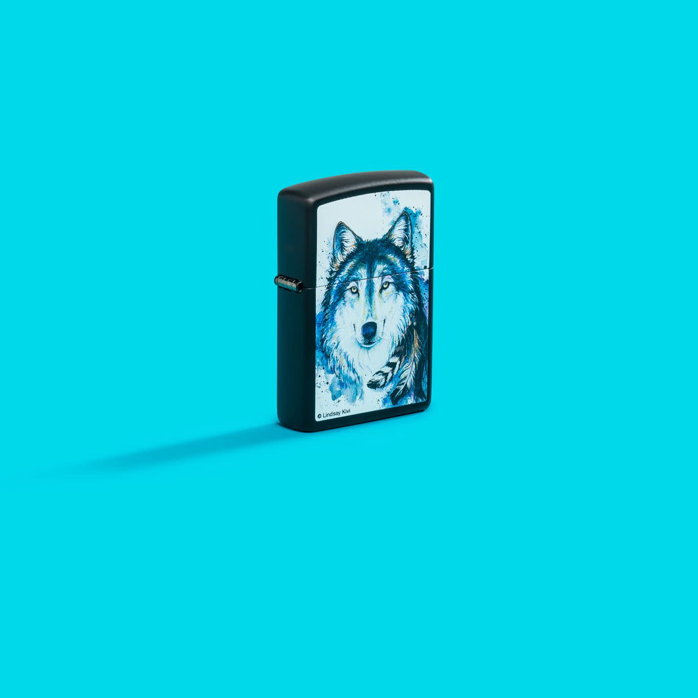 Lifestyle image of Zippo Lindsay Kivi Black Matte Windproof Lighter on an aqua blue background.
