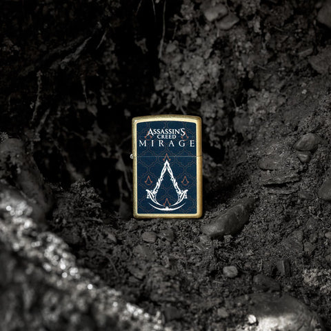 Lifestyle image of Zippo Assassins Creed® Mirage Reg Street Brass Windproof Lighter on a rocky background.