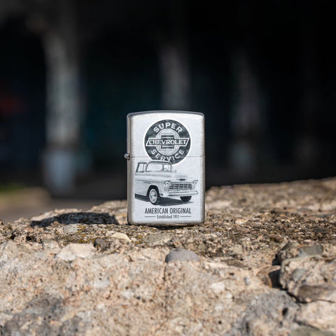 Lifestyle image of Zippo Chevrolet Street Chrome Pocket Lighter standing on a rock.