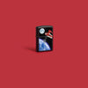 Lifestyle image of Zippo Earth Mix Design Texture Print Black Matte Windproof Lighter on a red background.