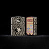 Lifestyle image of two Zippo NFL San Francisco 49ers Super Bowl Commemorative Armor Black Ice Windproof Lighters with a black background.