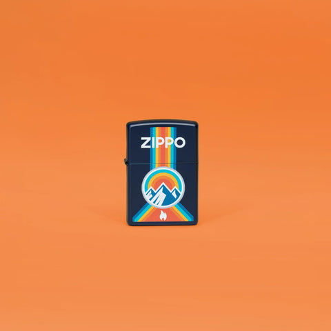 Lifestyle image of Zippo Logo Mountain Outdoor Logo Navy Matte Windproof Lighter standing in an orange scene.