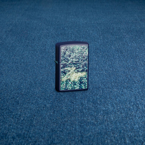 Lifestyle image of Zippo Design Navy Matte Windproof Lighter standing on a denim surface.