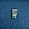 Lifestyle image of Zippo Design Navy Matte Windproof Lighter standing on a denim surface.