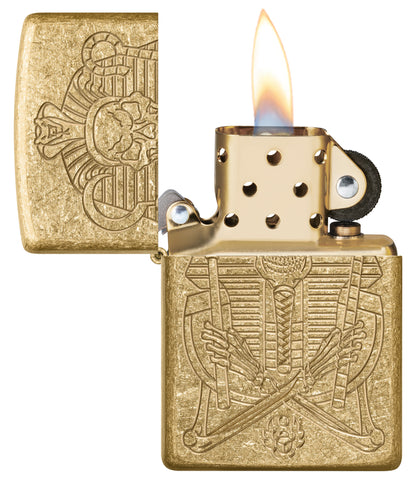 Zippo Mummy Design ArmorÂ® Tumbled Brass Windproof Lighter with its lid open and lit.