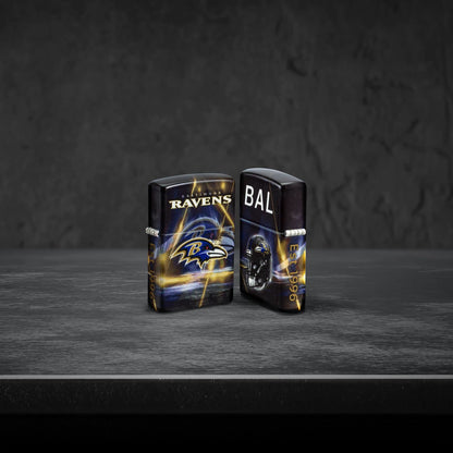 Lifestyle image of two Zippo NFL Baltimore Ravens 540 Matte Windproof Lighters, one showing the front of the lighter and the other showing the back, standing on a dark grey surface.