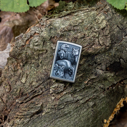 Lifestyle image of Zippo Animal Kingdom Design Satin Chrome Windproof Lighter laying on a fallen tree limb.