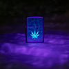 Zippo Cannabis Design Black Light Black Matte Windproof Lighter glowing in a black light.