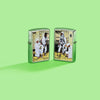Lifestyle image of two Zippo Norman Rockwell Astronaut Street Chrome Windproof Lighters on a lime green background.