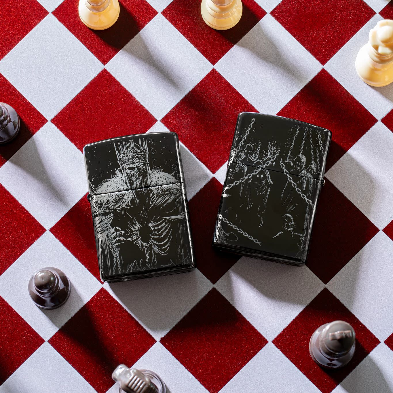Lifestyle image of Zippo Skull King Design High Polish Black Windproof Lighters laying on a chess board.