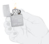 Zippo James Bond Satin Chrome Windproof Lighter lit in hand.