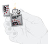 Zippo James Bond Brushed Chrome Windproof Lighter lit in hand.