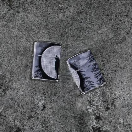 Lifestyle image of Armor Wolf Design lighters laying flat showing the front and back of the design