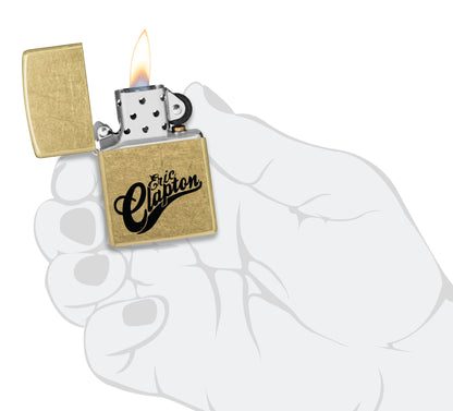 Zippo Eric Clapton Reg Street Brass Windproof Lighter lit in hand.