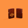Lifestyle image of two Zippo Harley-Davidson® 540 Tumbled Brass Windproof Lighters on an orange background.