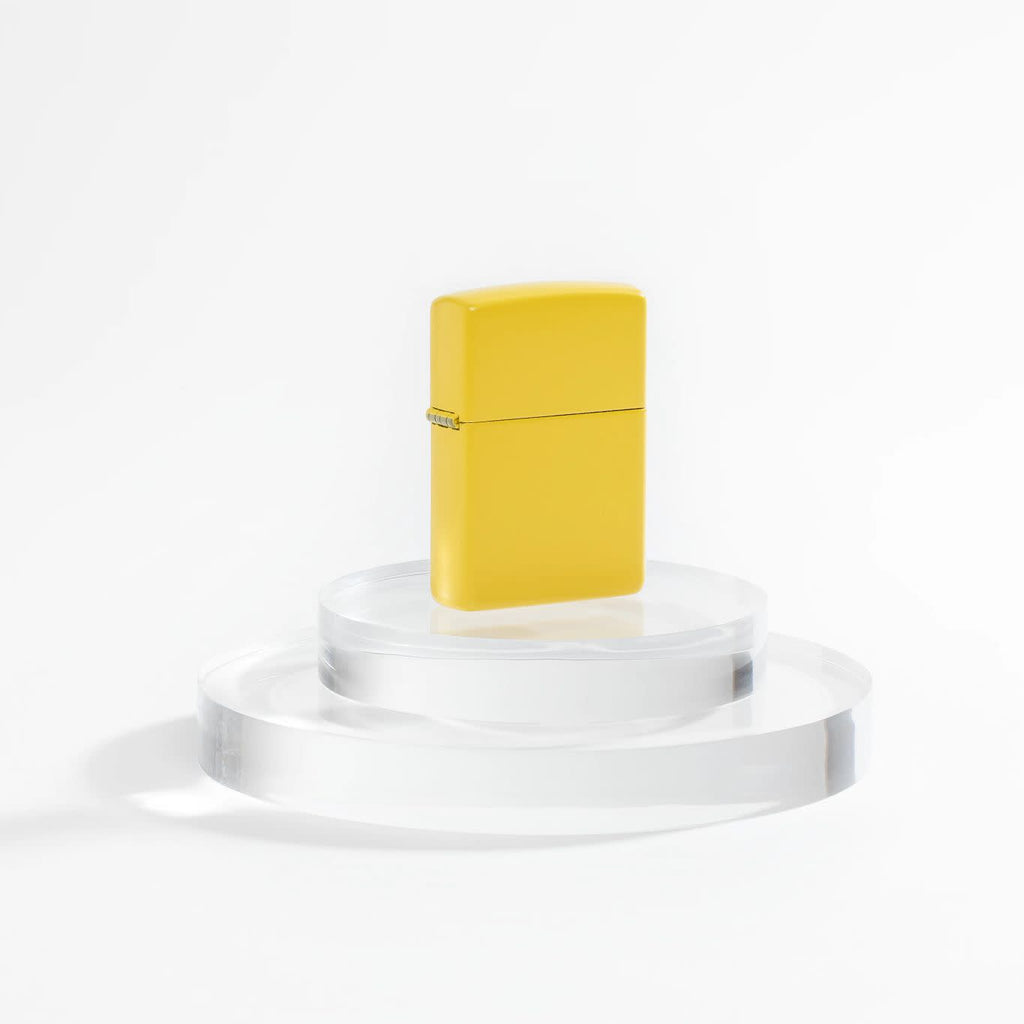 Lifestyle image of Zippo Classic Sunflower Windproof Lighter on a clear pedestal and a white background.