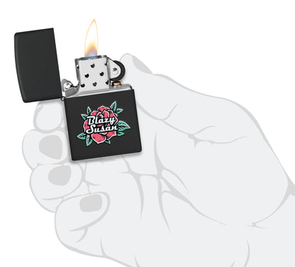Zippo Blazy Susan™ Logo Design Black Matte Windproof Lighter lit in hand.