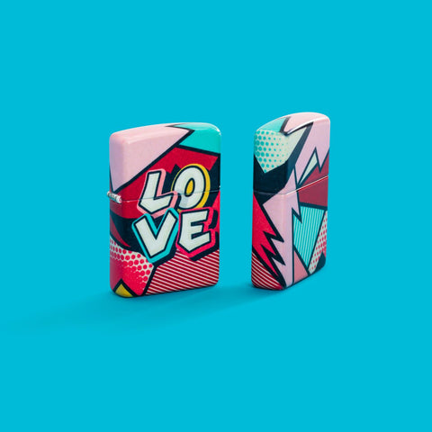 Lifestyle image of two Zippo Love Design 540 Matte Windproof Lighters on an aqua blue background.
