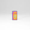 Lifestyle image of Zippo Cannabis Leaf Design Slim Multi Color Windproof Lighter standing in a grey scene.