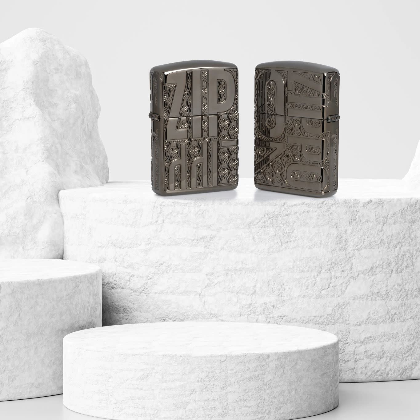 Lifestyle image of two Zippo Reverse Carve Zippo Design ArmorÂ® Black IceÂ® Windproof Lighters standing on a white stone cylinder: one showing the front of the lighter, and one showing the back.