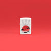 Lifestyle image of Zippo Red Moon Design White Matte Windproof Lighter standing in a red scene.