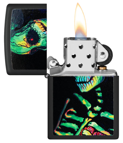 Zippo Glowing Skull Design Black Matte Windproof Lighter with its lid open and lit.