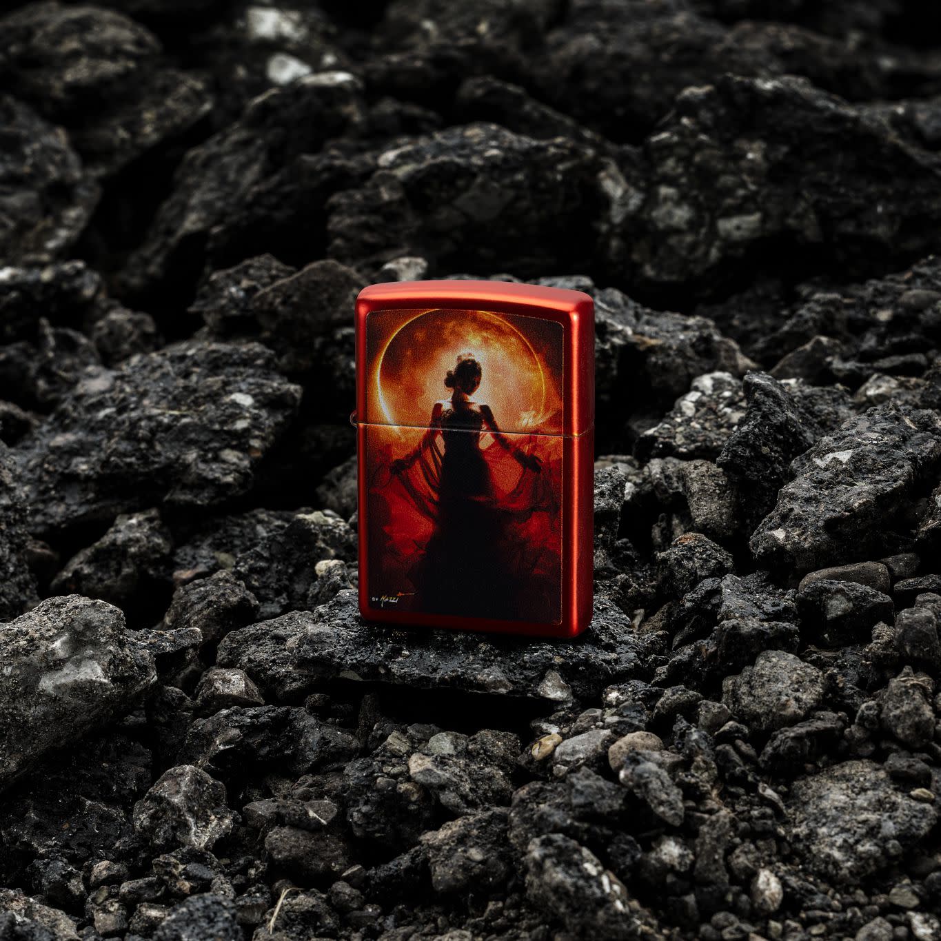 Lifestyle image of Zippo MazziÂ® Woman Silhouette Metallic Red Windproof Lighter standing on crumbled blacktop.