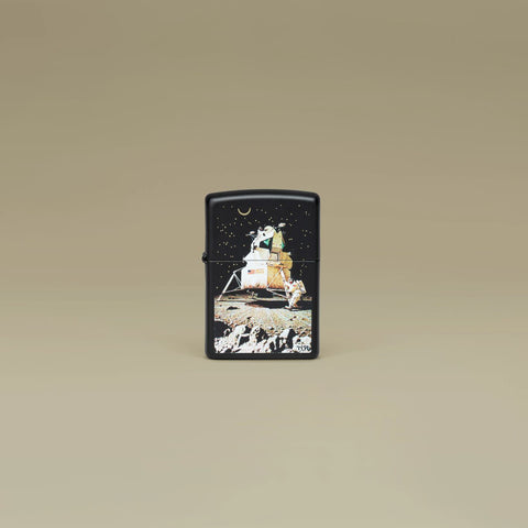 Lifestyle image of Zippo Norman Rockwell Man on the Moon Black Matte Windproof Lighter standing in a brown scene.