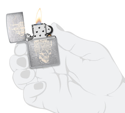 Zippo Skull Castle Design Brushed Chrome Windproof Lighter lit in hand.