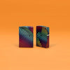 Lifestyle image of Zippo Rainbow Pattern Design 540 Color Windproof Lighters standing in an orange scene.