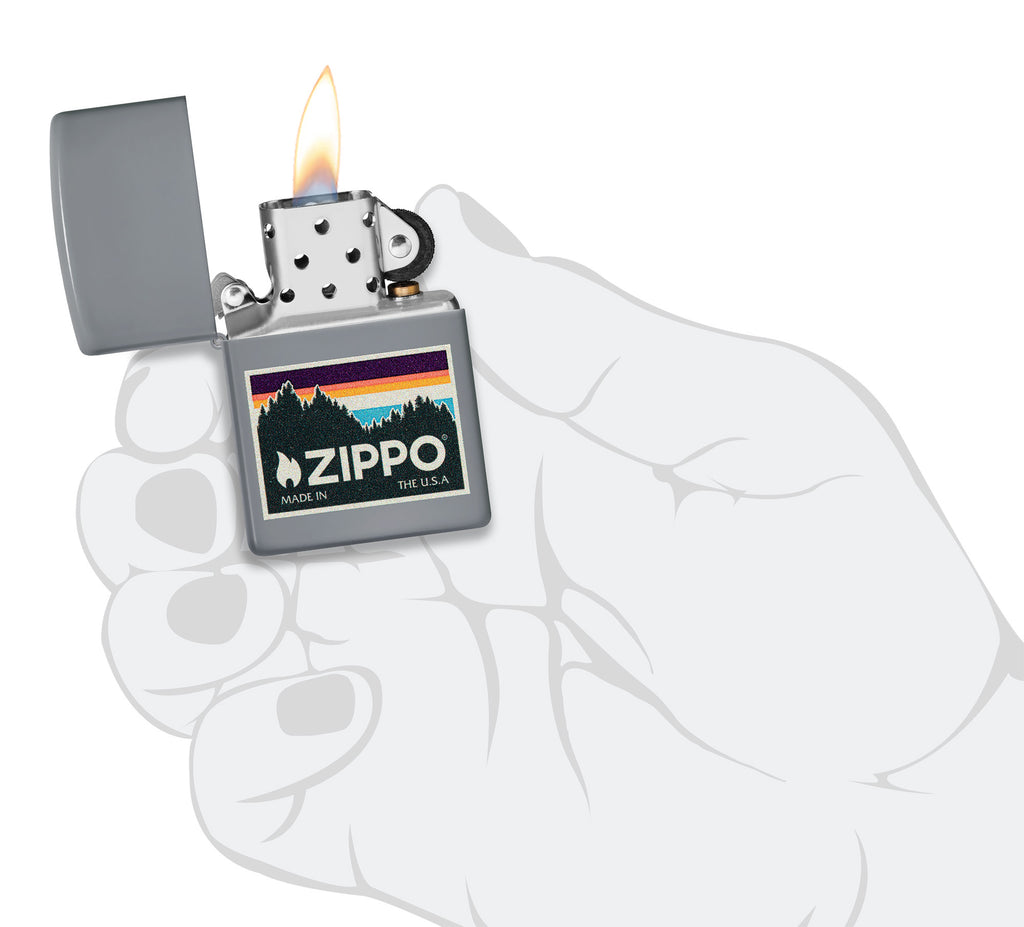 Outdoor Zippo Logo Design Flat Grey Windproof Lighter lit in hand.